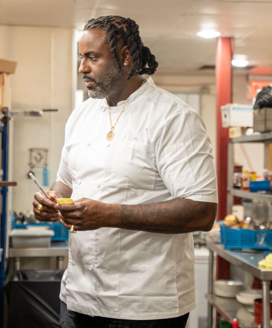 Chef Willie Wallace working in a kitchen wearing a white chef jacket
